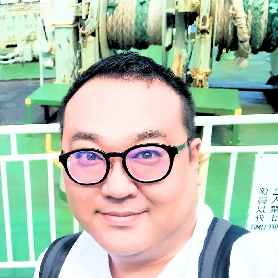 フェリーの甲板に立つ栗林康弘